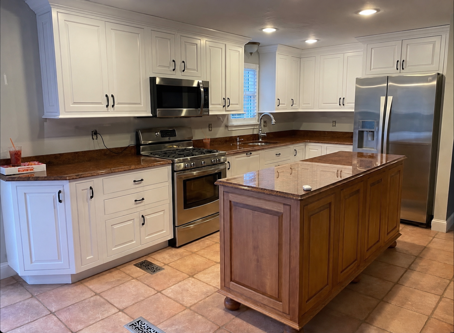 Finished butcher block countertops in a Cape Cod kitchen completed by Compass Home Group