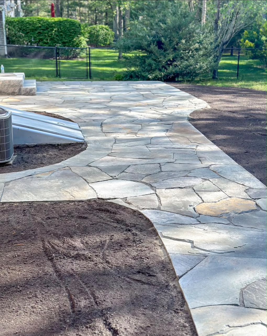 Natural stone garden path in a landscaped Cape Cod yard