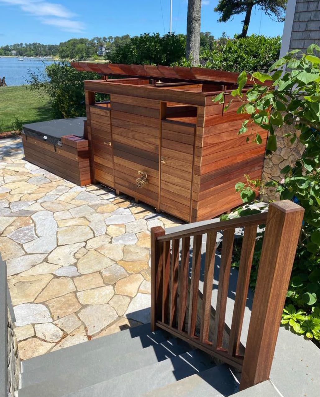 Wood deck with integrated spa and waterfront view