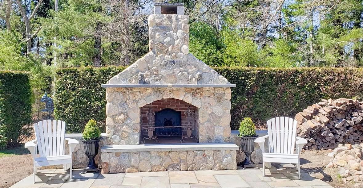 Natural stone outdoor fireplace built for a Cape Cod patio